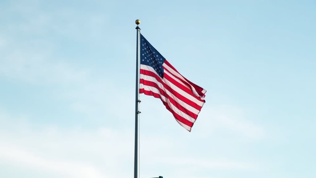 A large American flag flying respectfully at half-staff on a flagpole