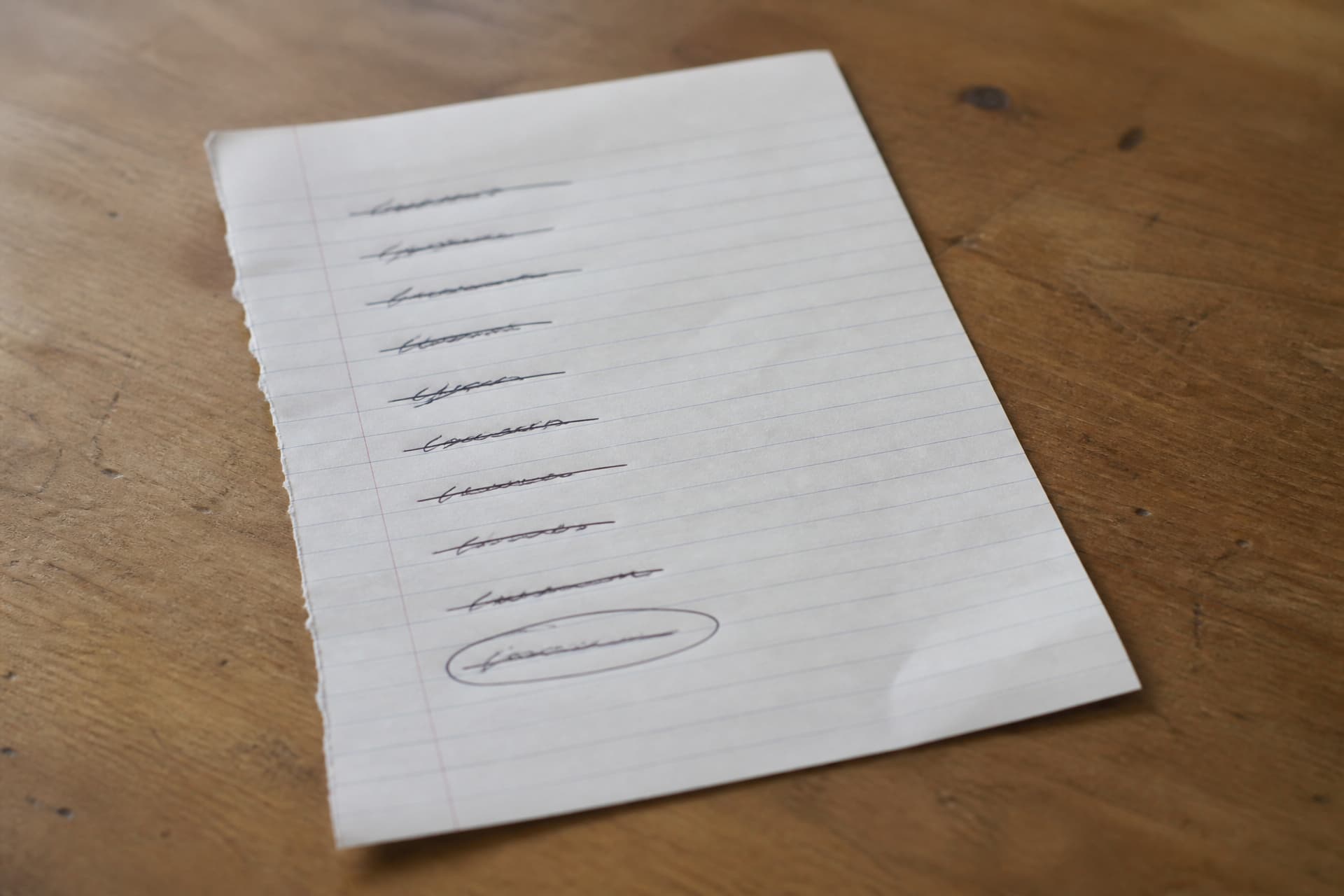 A handwritten list of online services on lined paper, most crossed through, with an email account circled at the bottom of the page
