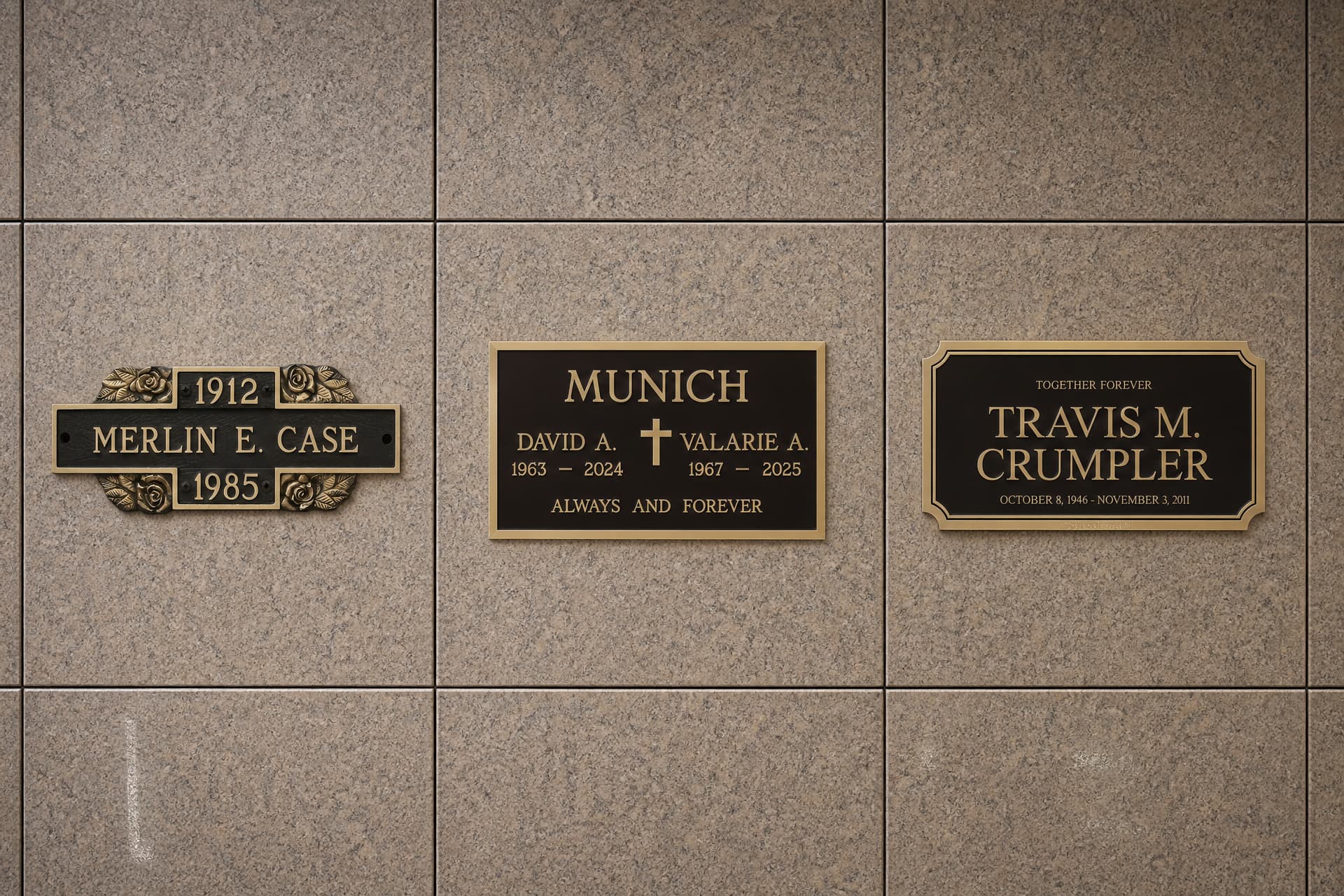 Three cast bronze niche plaques mounted upright on a polished granite columbarium wall, each carrying a name and dates