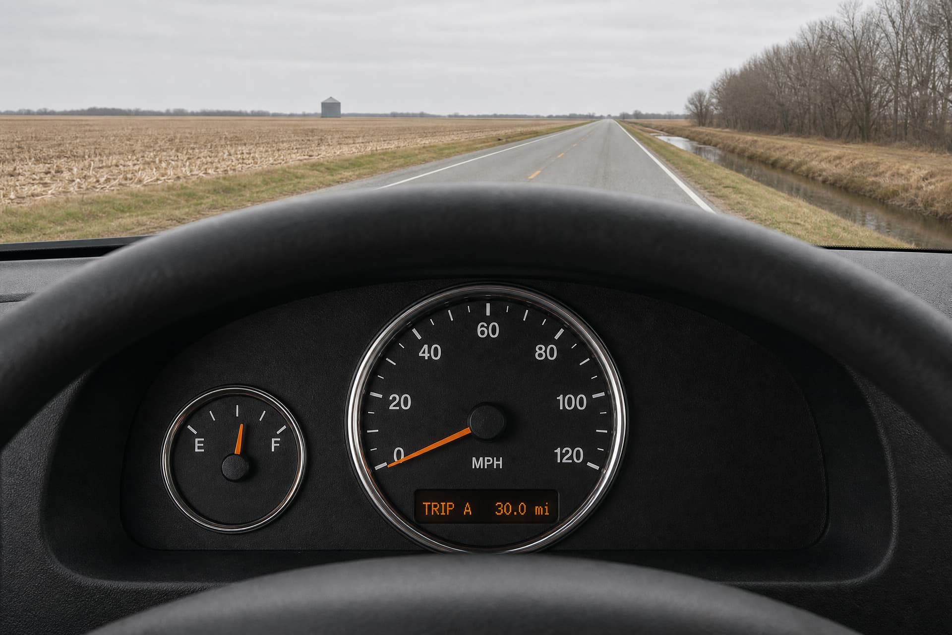 From the driver's seat of a stopped van, a black instrument cluster whose trip meter reads 30.0 miles, a flat Eastern Shore road beyond the windshield