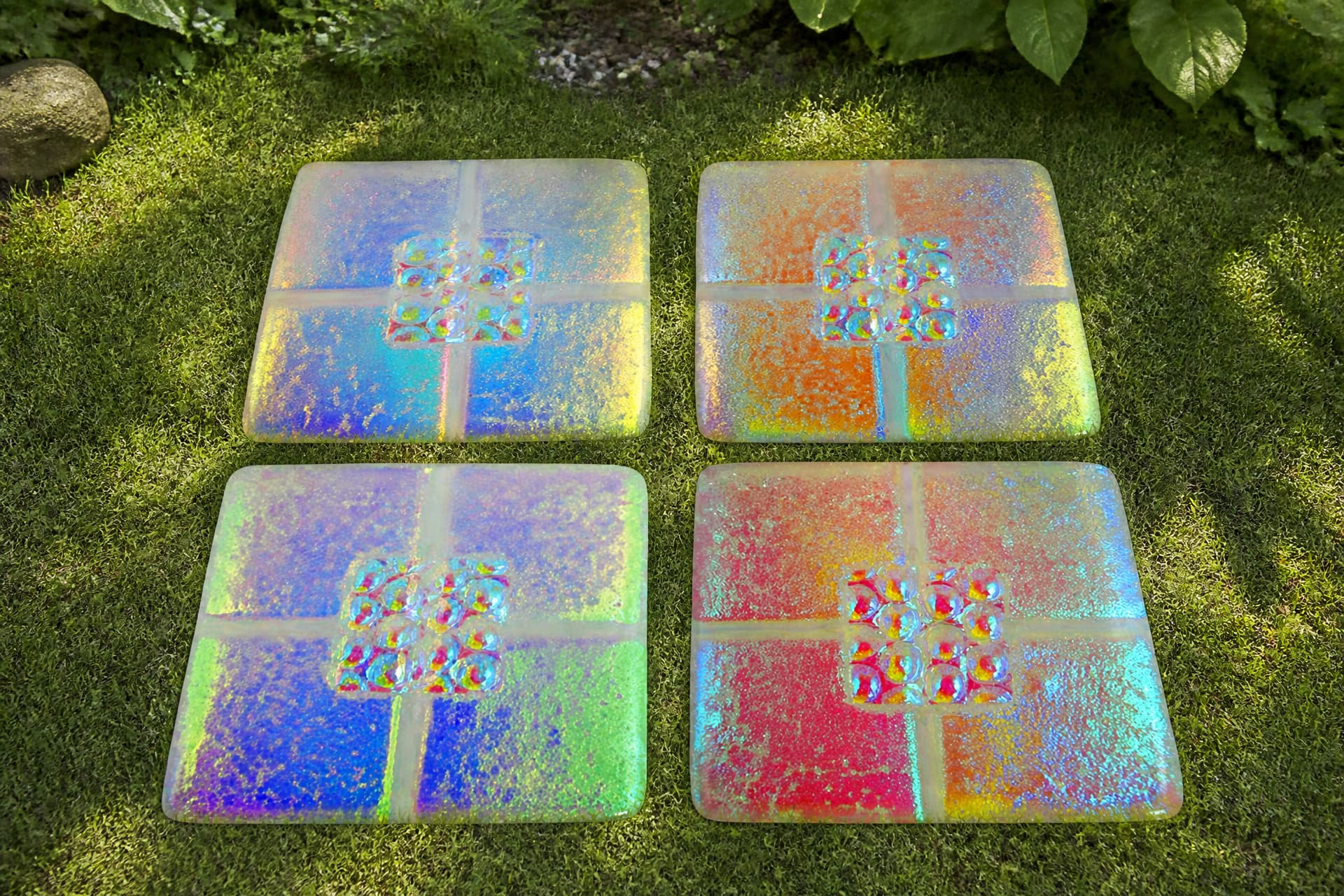 Engraved pet memorial stones and keepsake tiles arranged on a wooden surface