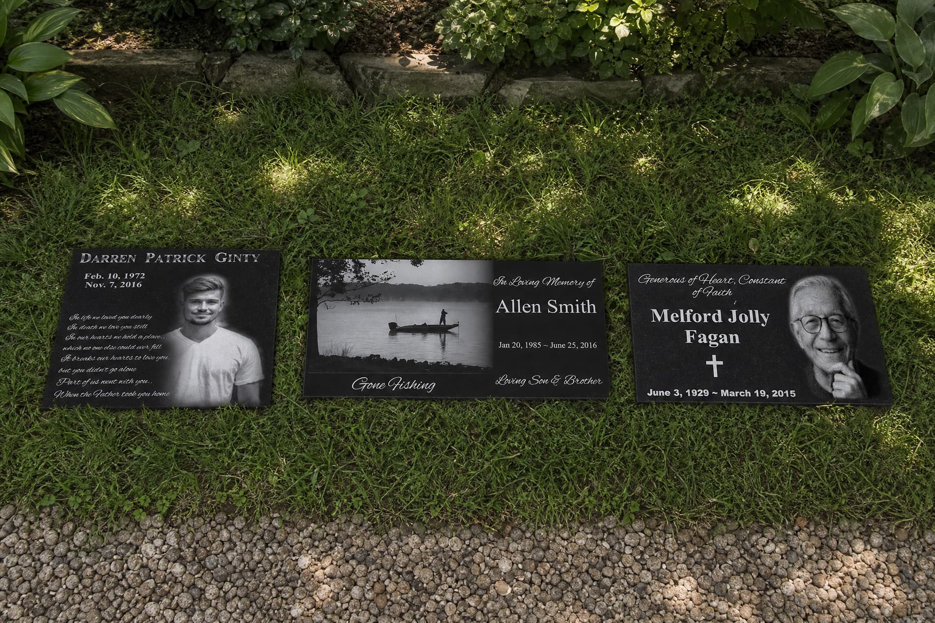 3 memorials shown lying flat in a shaded garden bed