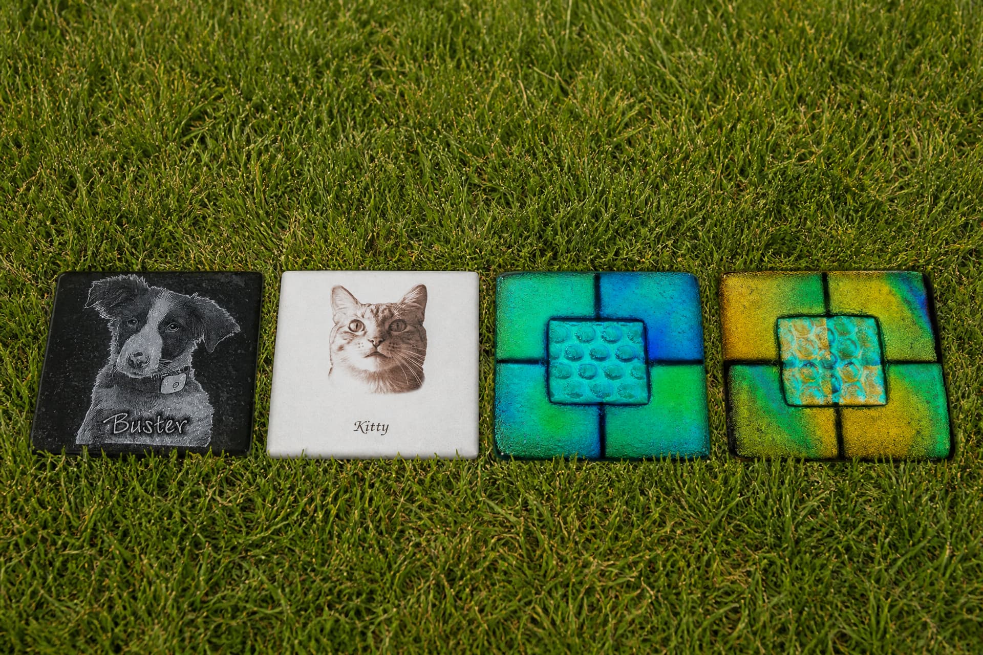 A selection of pet memorial keepsakes including photo frames and engraved tiles