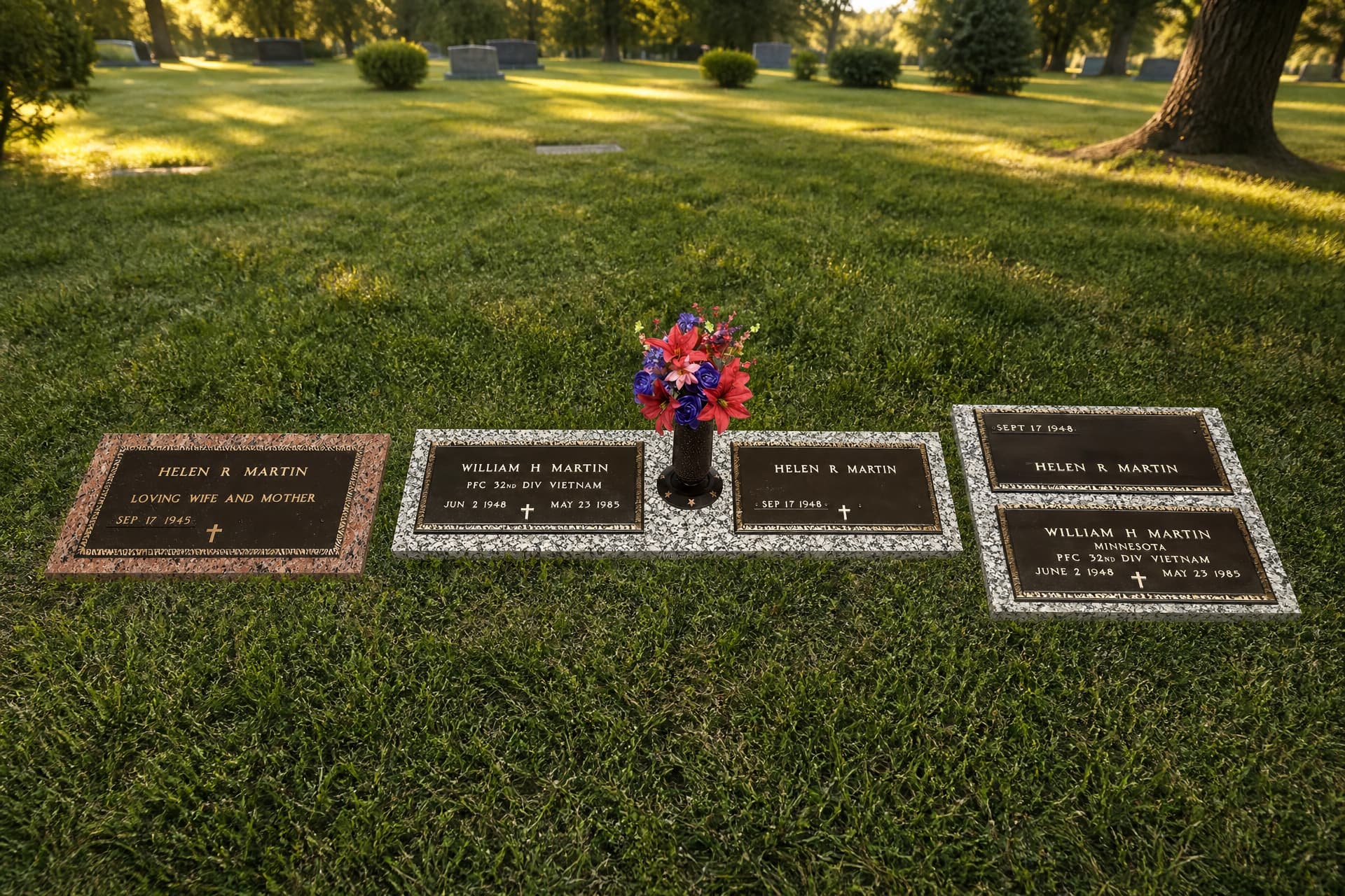 3 memorials shown set flush in a sunlit cemetery lawn