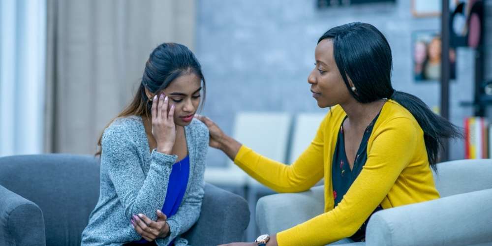 Counselor helping young lady with grief